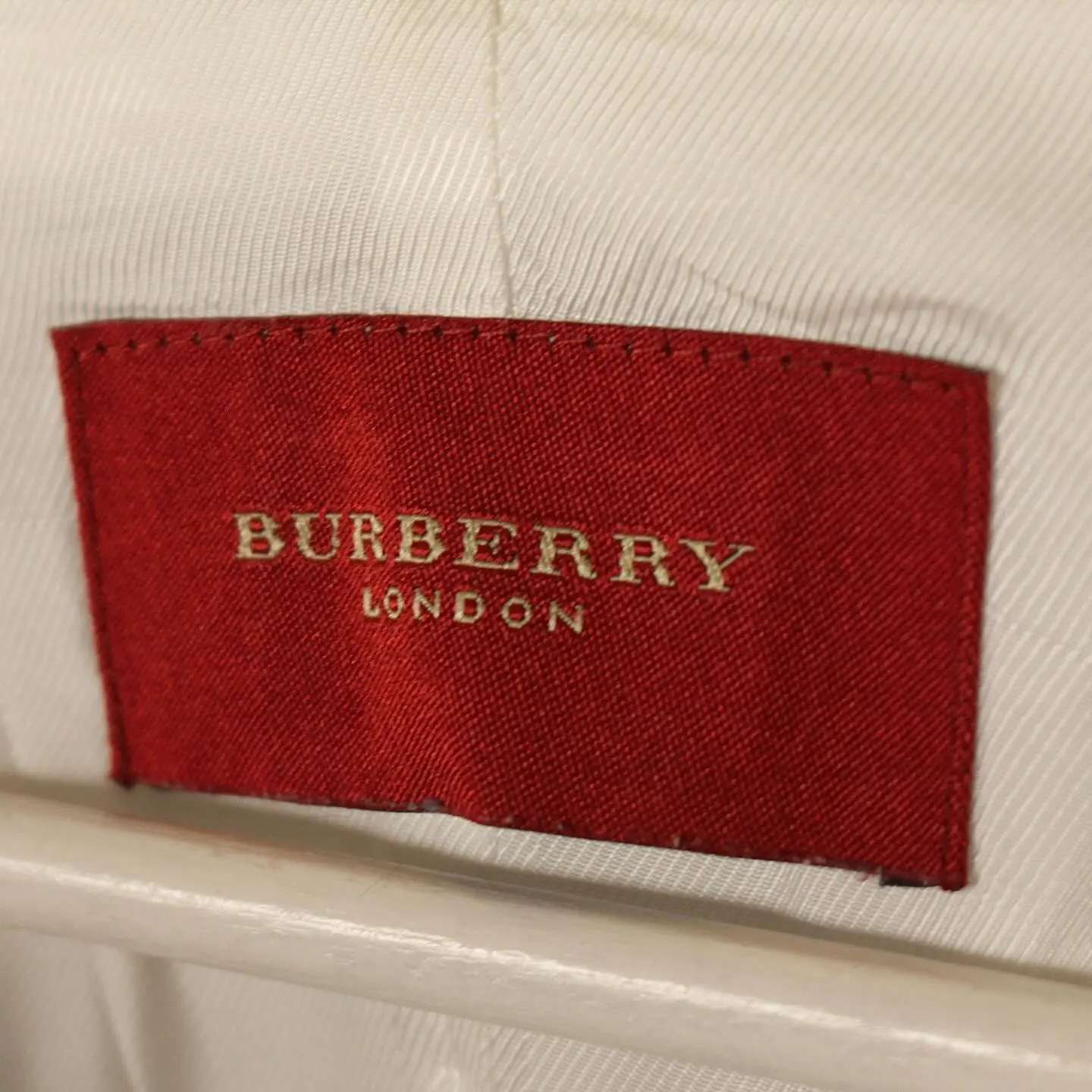White Burberry women’s zippered down jacket, belted waist, view 1 of 11
